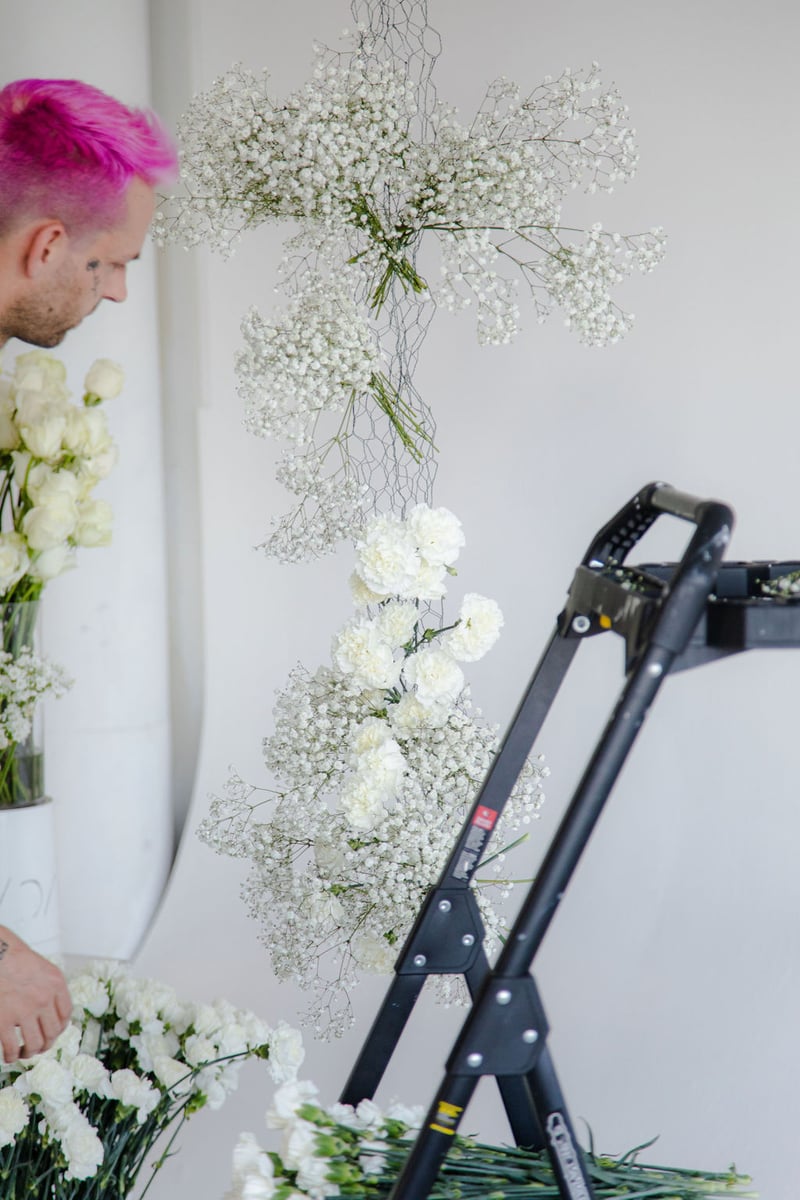 hanging floral arch installation with baby's breath and carnations