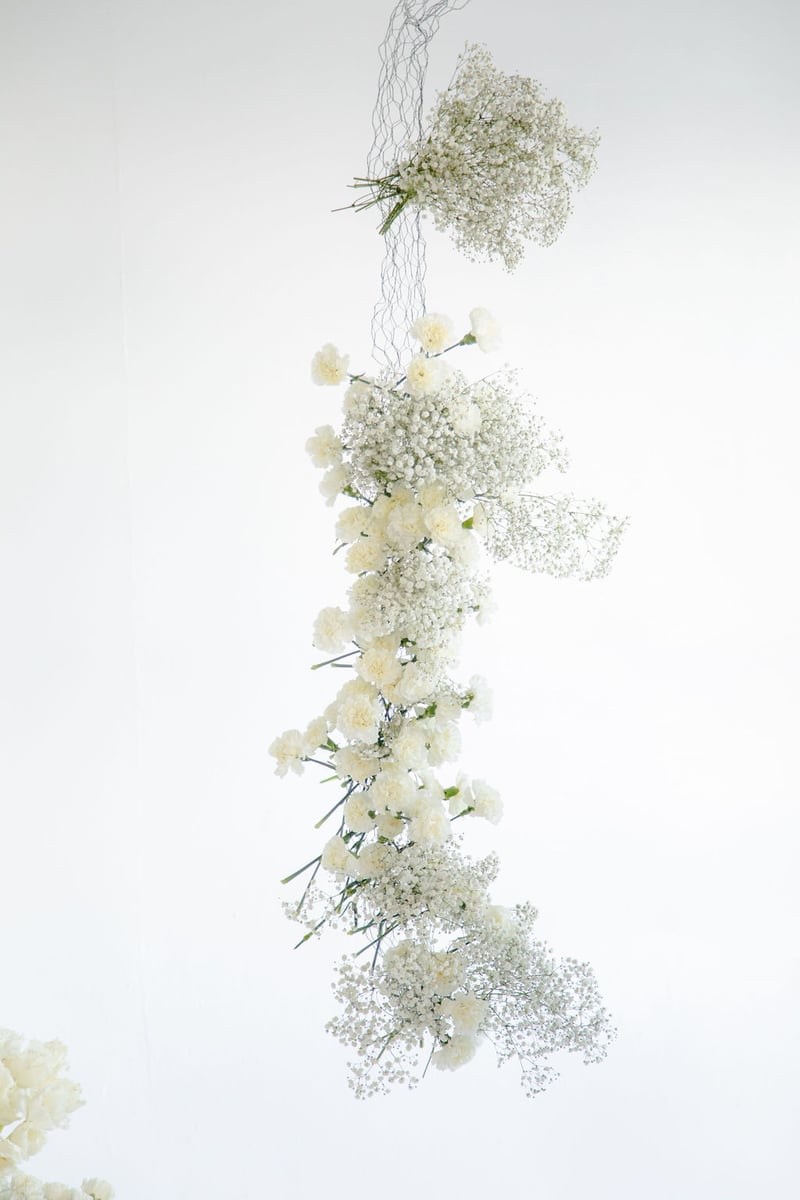 hanging floral arch installation with baby's breath and carnations