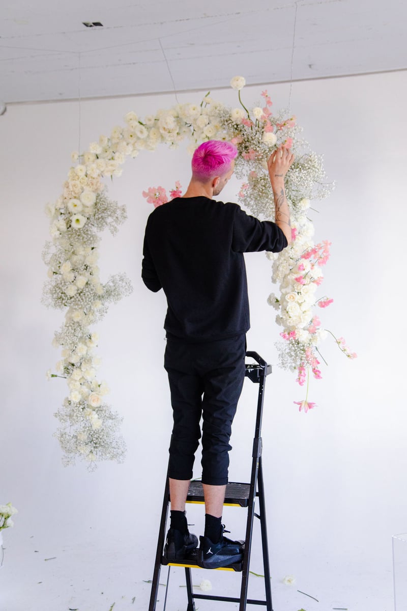 blush, pink, and white hanging floral arch installation
