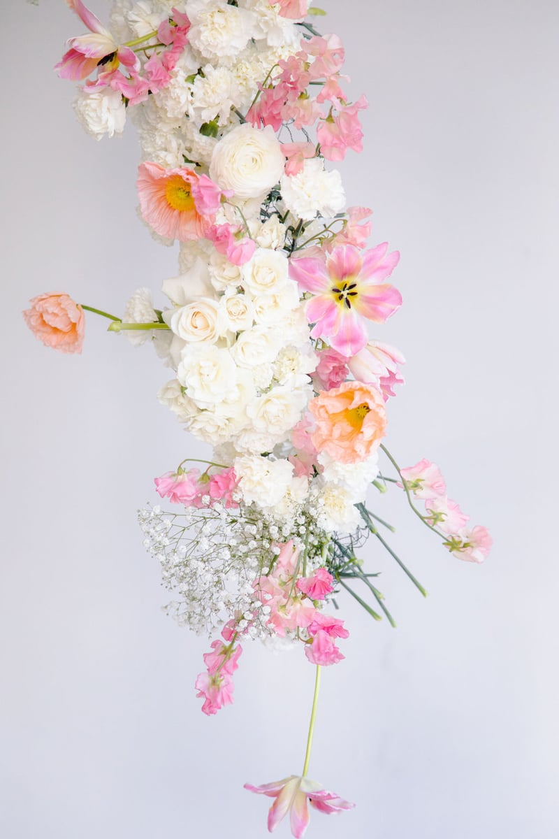 blush, pink, and white hanging floral arch installation
