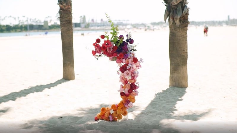 porch wedding installation - flowers cascading down a column - dahlias, ranunculus, sweet peas