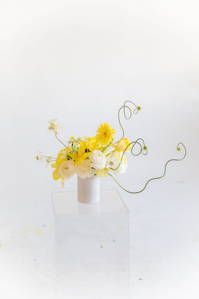 cream, white, and yellow flower arrangement by Anthony Maslo