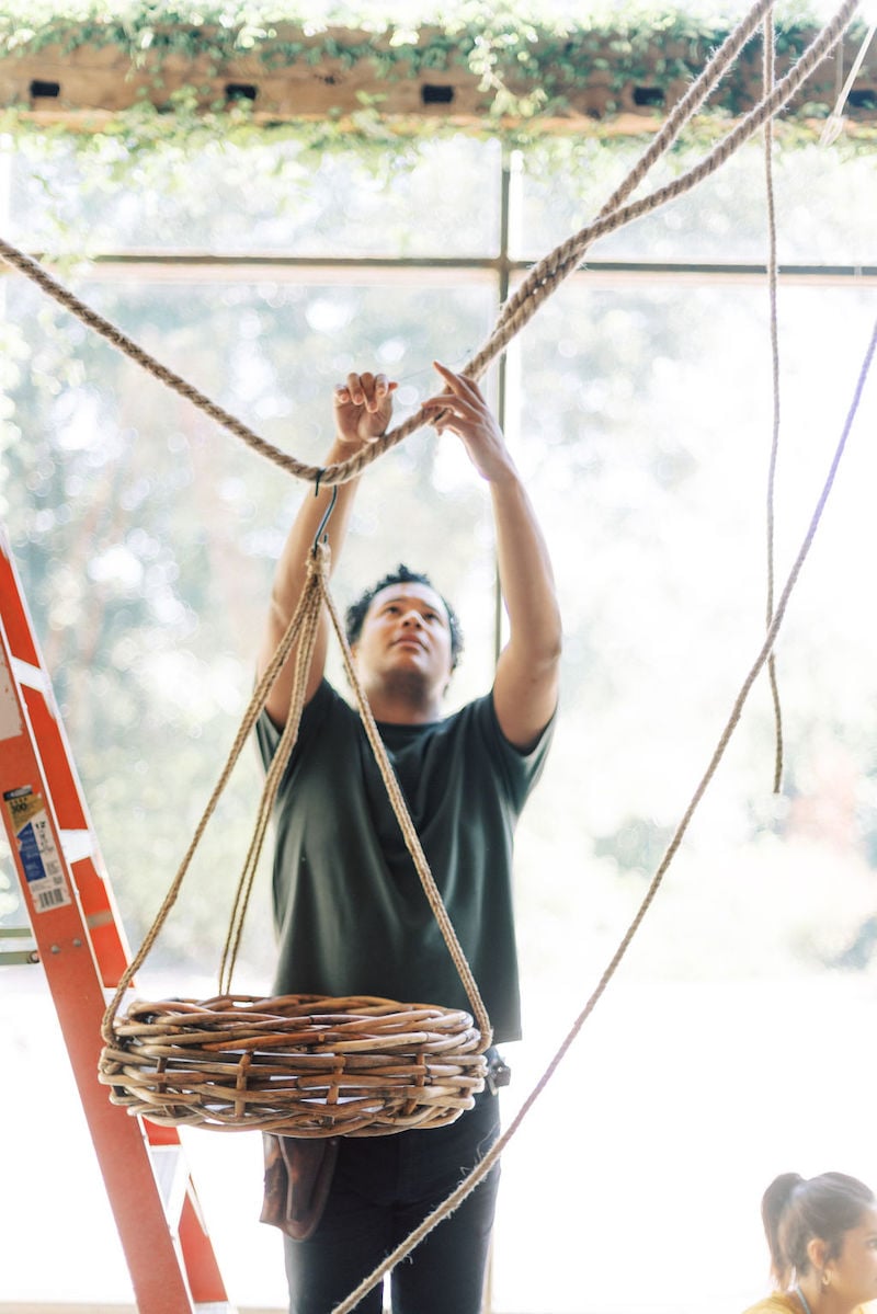 Shean Strong setting up Accent Decor baskets for group installation at the Mayesh Design Star workshop in Austin TX